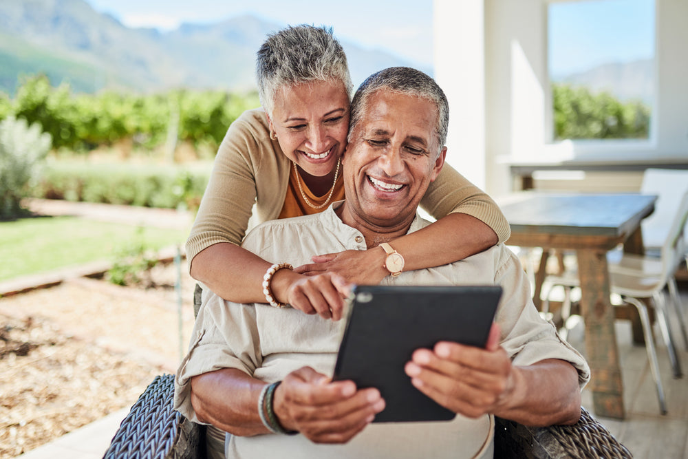 older couple smiling at tablet