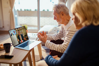 older couple talking to counselor over a video call 